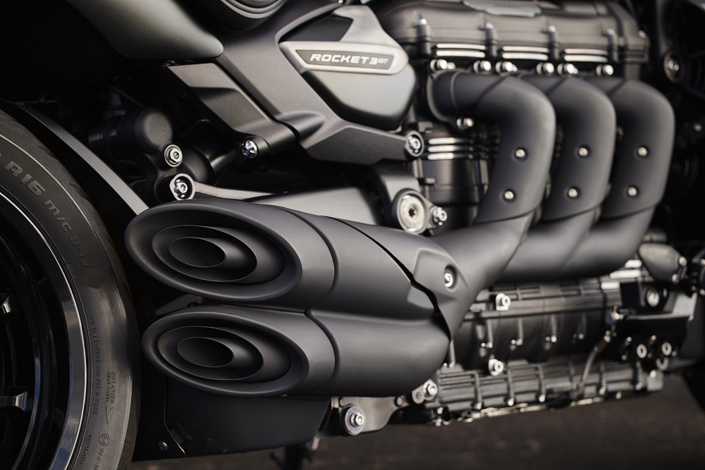 Close shot of the blacked-out three-cylinder engine and exhaust