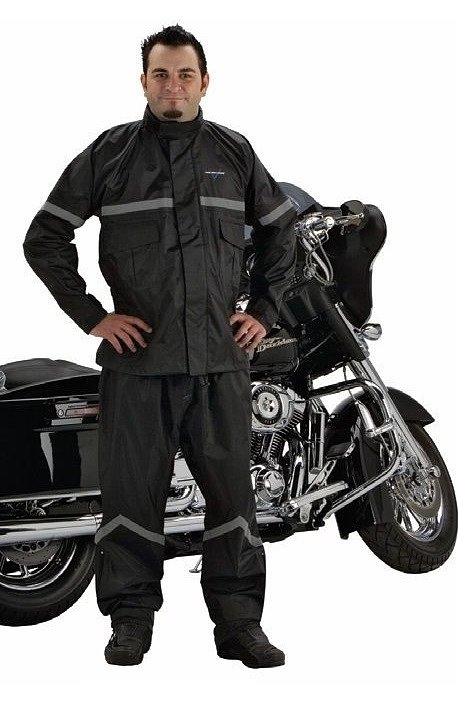 man wearing a Nelson-Rigg Stormrider rain suit and standing in front of a black cruiser motorcycle
