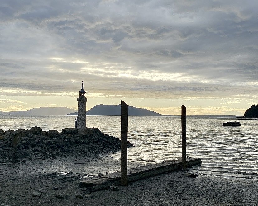 lighthouse by the bay at sunset