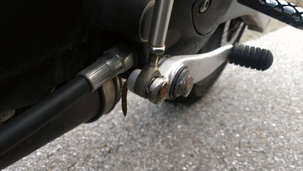 bent rusty nail replacing a missing bolt in the shift lever