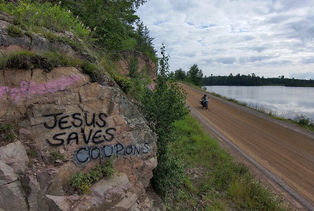 overhead view of a rider on a dirt road by a lake