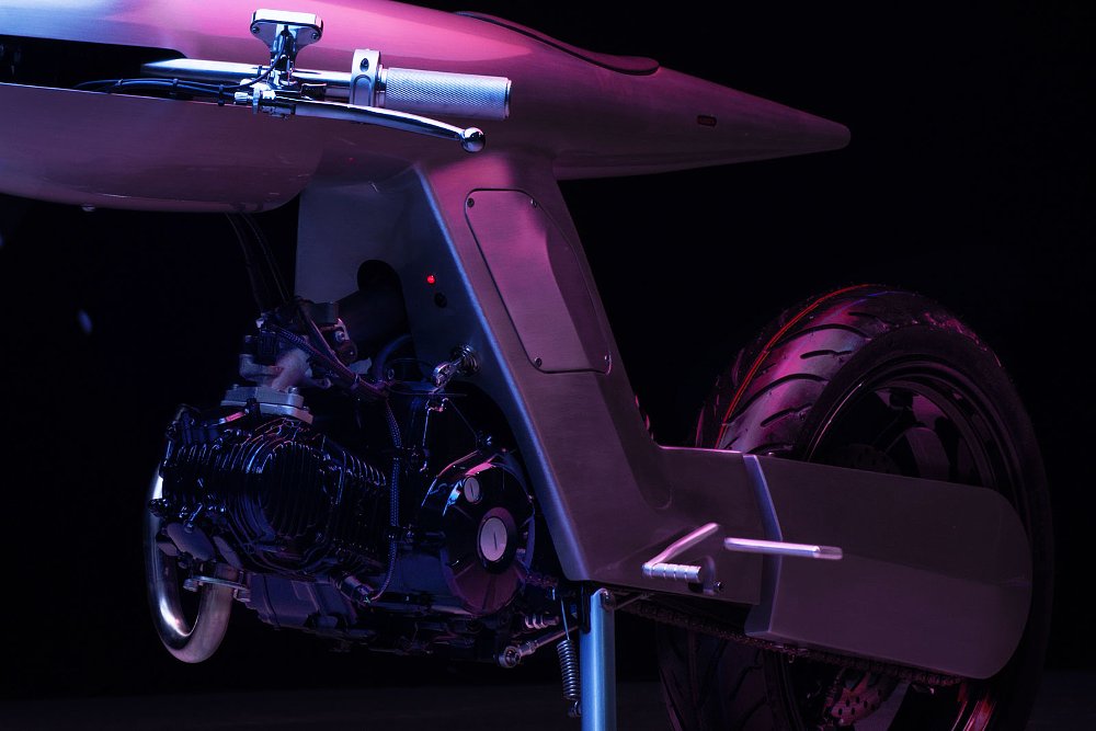 dark studio photo closeup of the simple, black, air-cooled horizontal engine