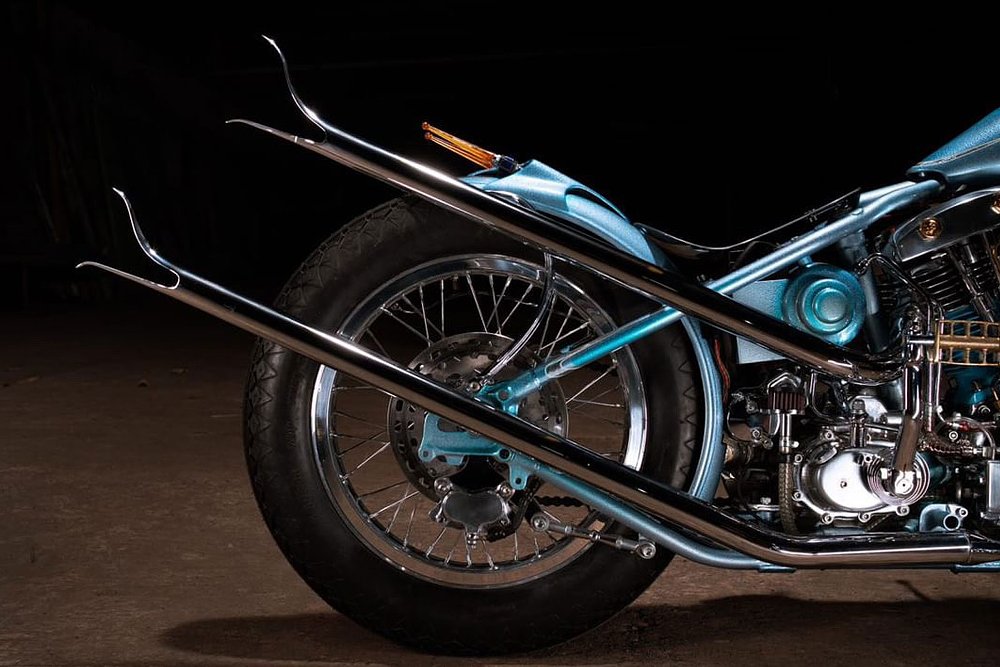 rear of the motorcycle with glowing yellow stalks extending back