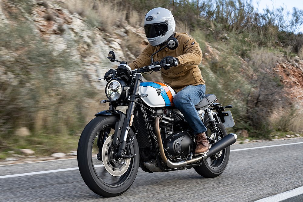 Dustin rides the Speed Twin 900 down a mountainside road.