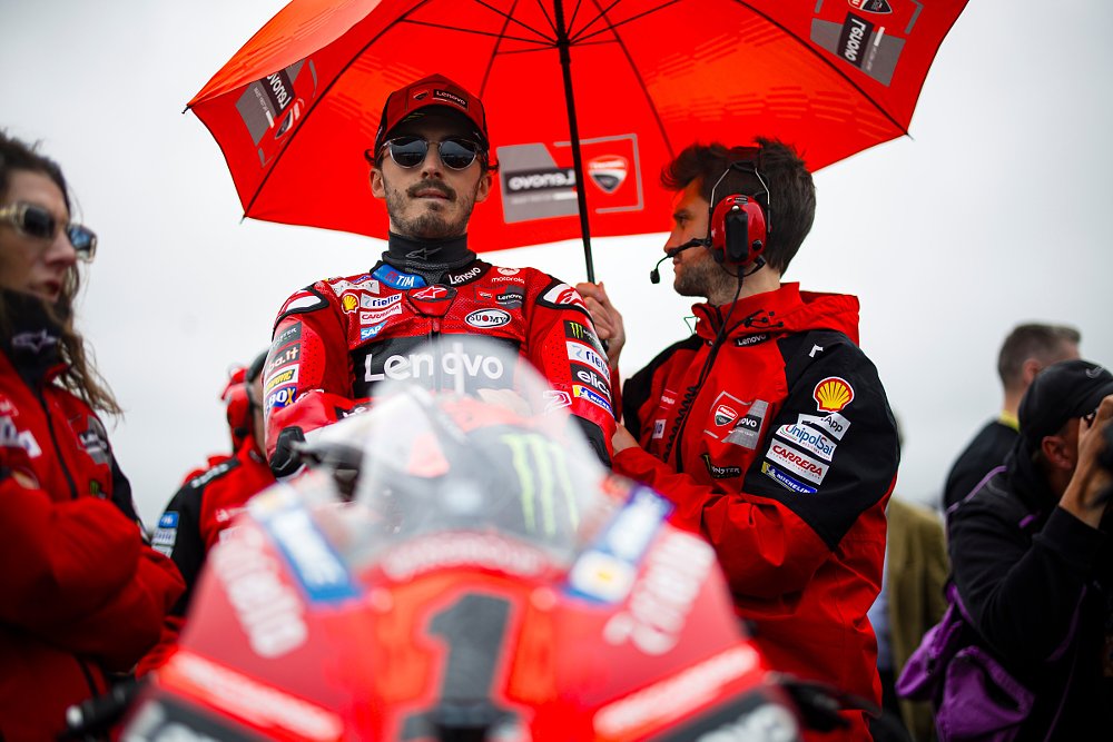 MotoGP champion Pecco Bagnaia sitting on the starting grid before a race with his eyes hidden by sunglasses