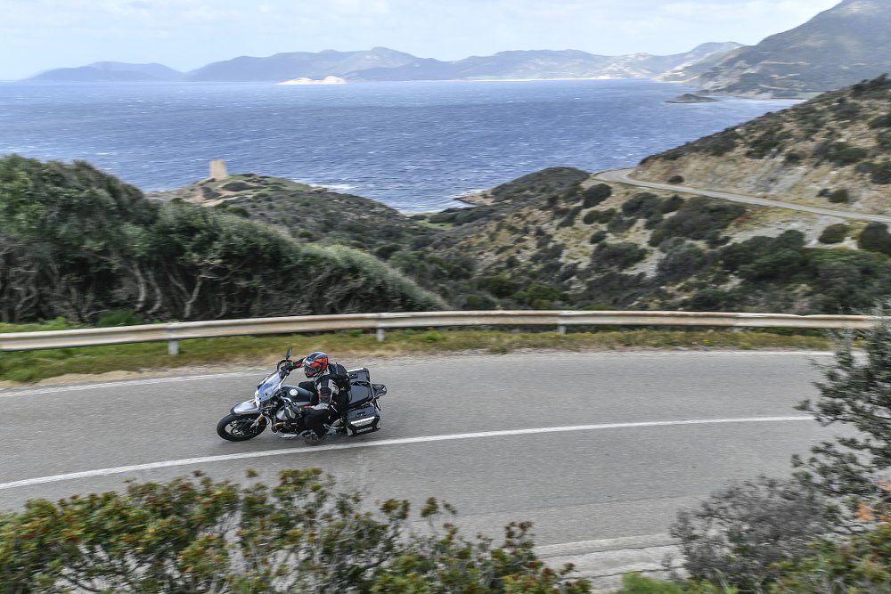 overhead view of a rider on a winding coastal road