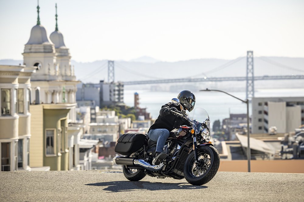 rider on an Indian Scout in San Francisco with the bridge in the distance