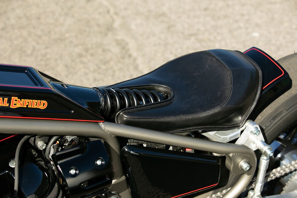 photo of the rear shock absorber and spring sitting in a cutout area of the rider's seat