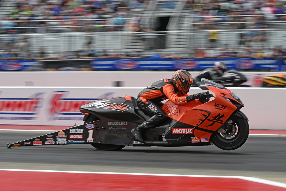 Herrera on his orange RevZilla Hayabusa at the start of a drag race, another competitor in the background