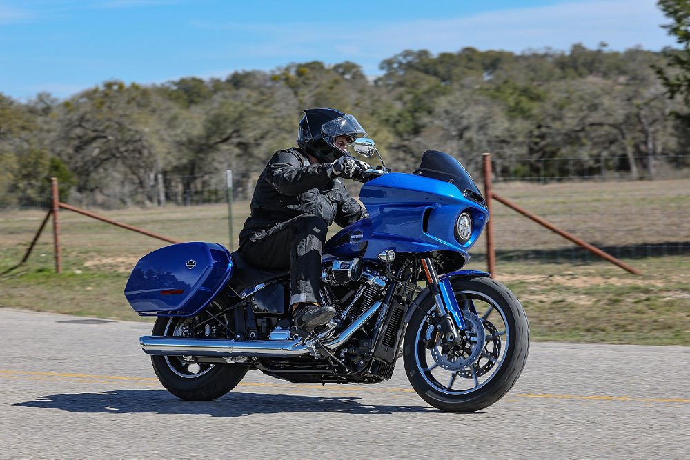 rider on a country road on a bright blue Low Rider ST with a fairing