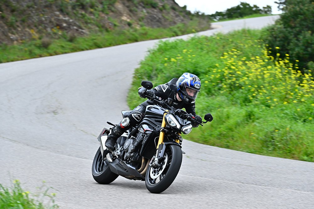 riding the Speed Triple RS on a curving hillside road
