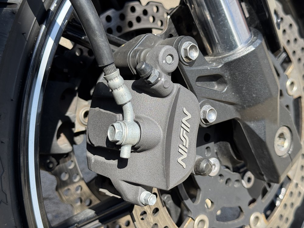 Motorcycle caliper with hose mounted low