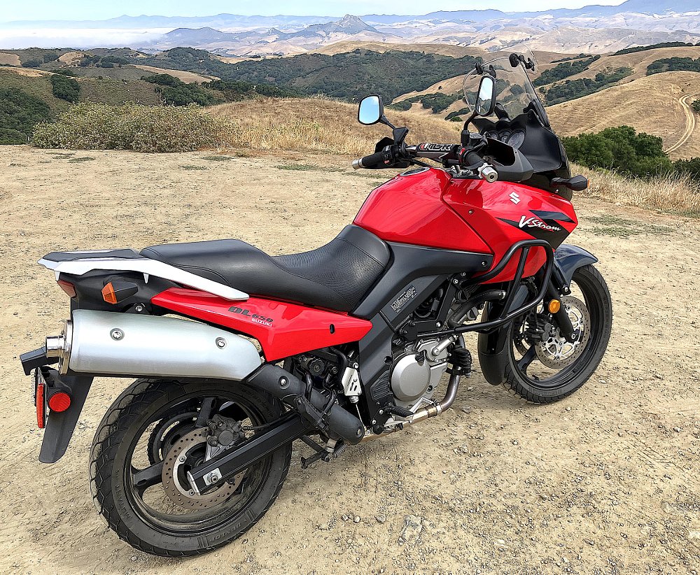 red V-Strom 650 parked at an overlook in the hills