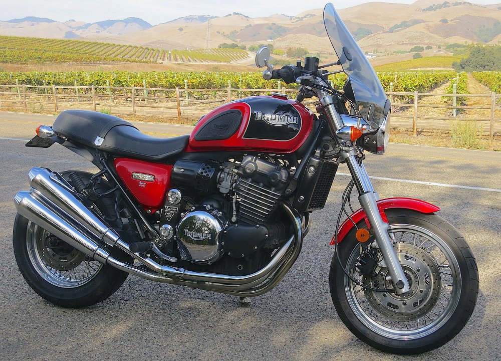 retro-looking Tunderbird Sport parked in front of vineyard fields