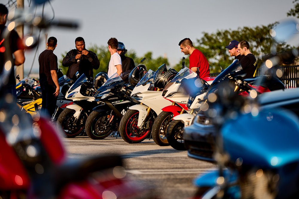 group of people enjoying a bike night at a RevZilla store