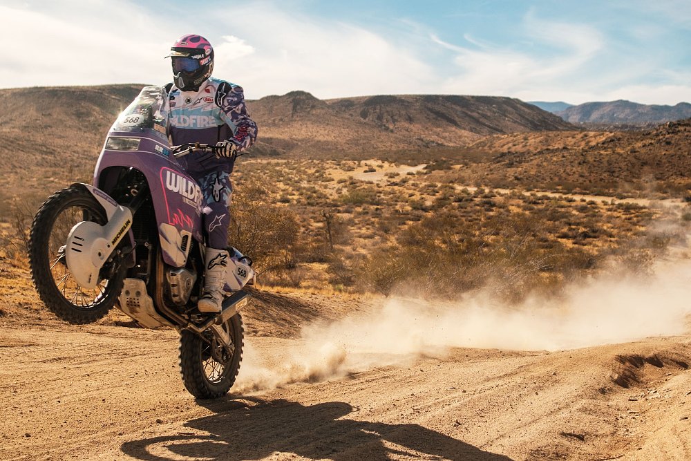 the custom rally bike doing a wheelie in the dirt