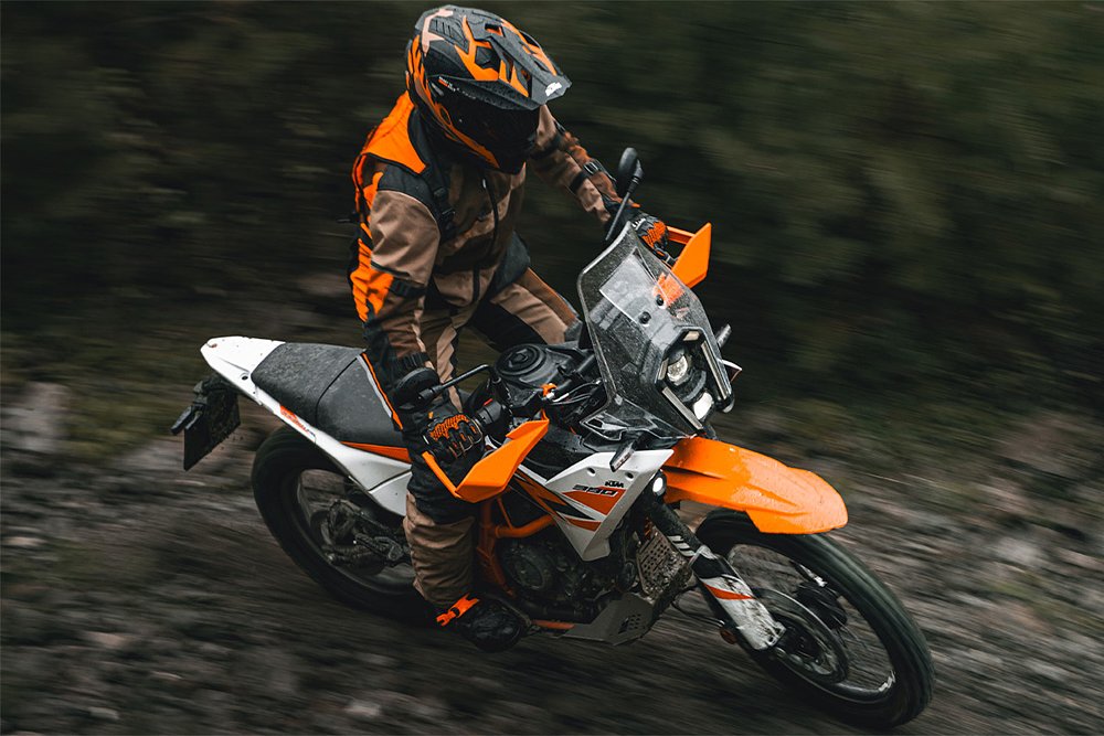 A rider navigates a forrest trail aboard the KTM 390 Adventure R.