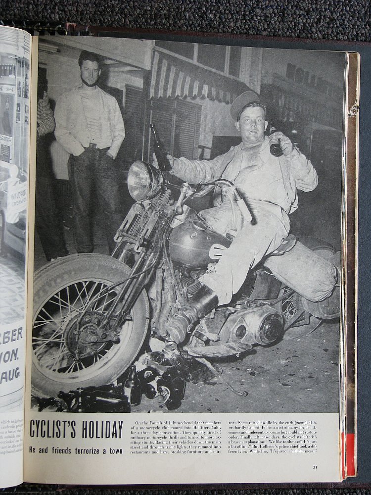 image of Life magazine page showing black and white photo of drunken man sitting on a motorcycle surrounded by empty beer bottles