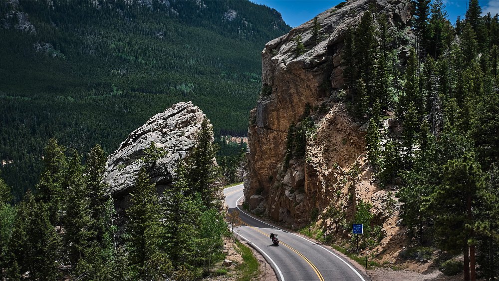 Dustin rides the XDiavel on a road cutting through a mountain.