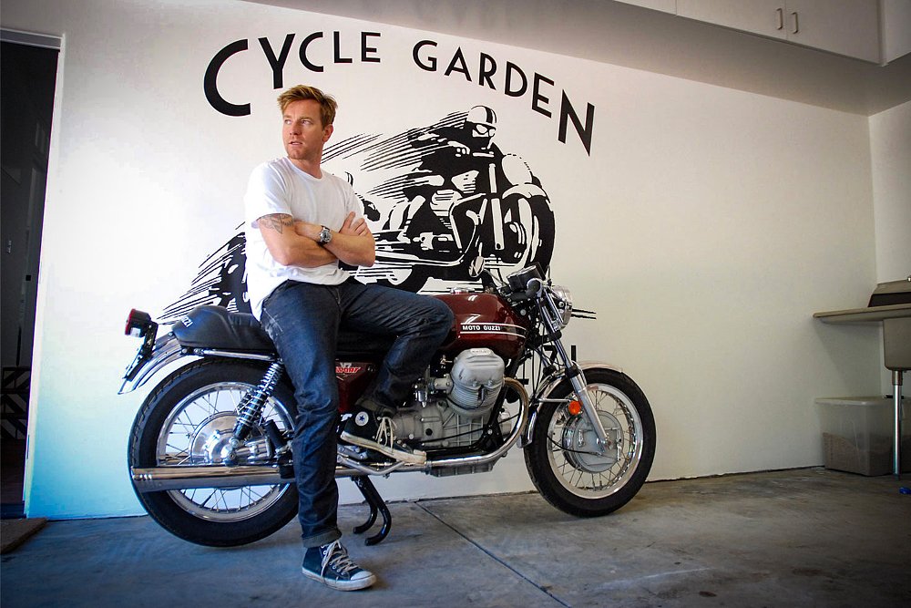 Ewan McGregor sits on his 1973 Moto Guzzi V7 Sport in the Cycle Garden shop.