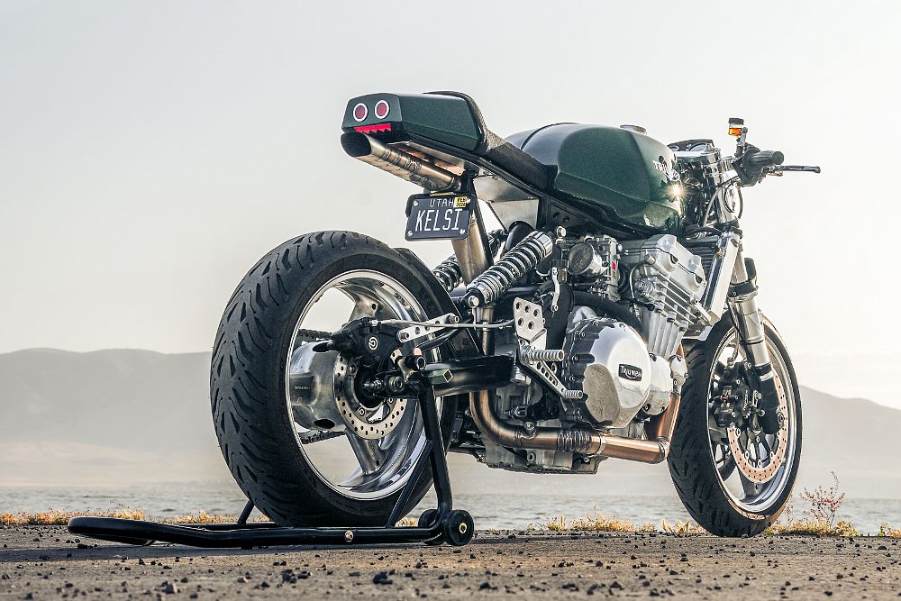 rear view of the motorcycle from a low angle showing the exhaust snaking under the engine and exiting under the tail section