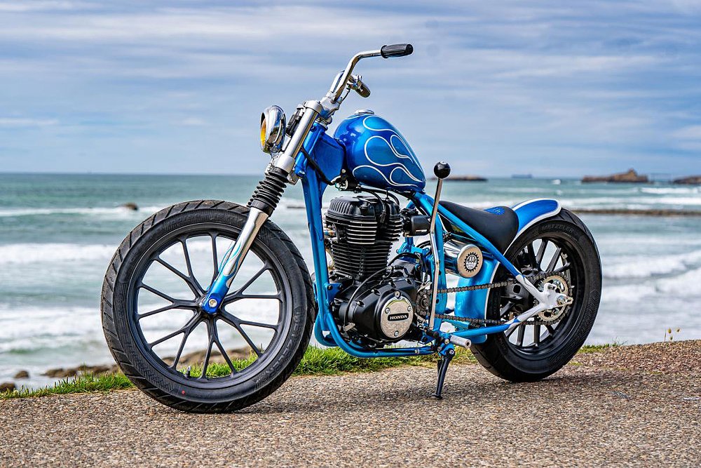 side view of the motorcycle showing the vertical single-cylinder engine and hand shifter