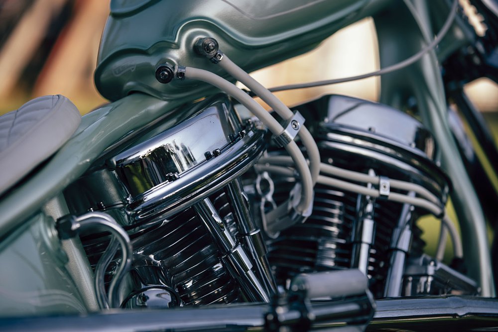 light green tank with fuel lines running to the chromed Panhead engine