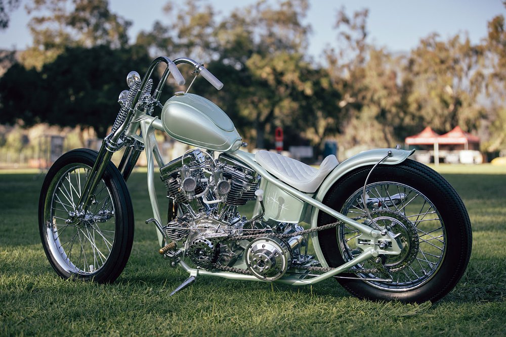 left side view of the chopper with light green paint and white seat