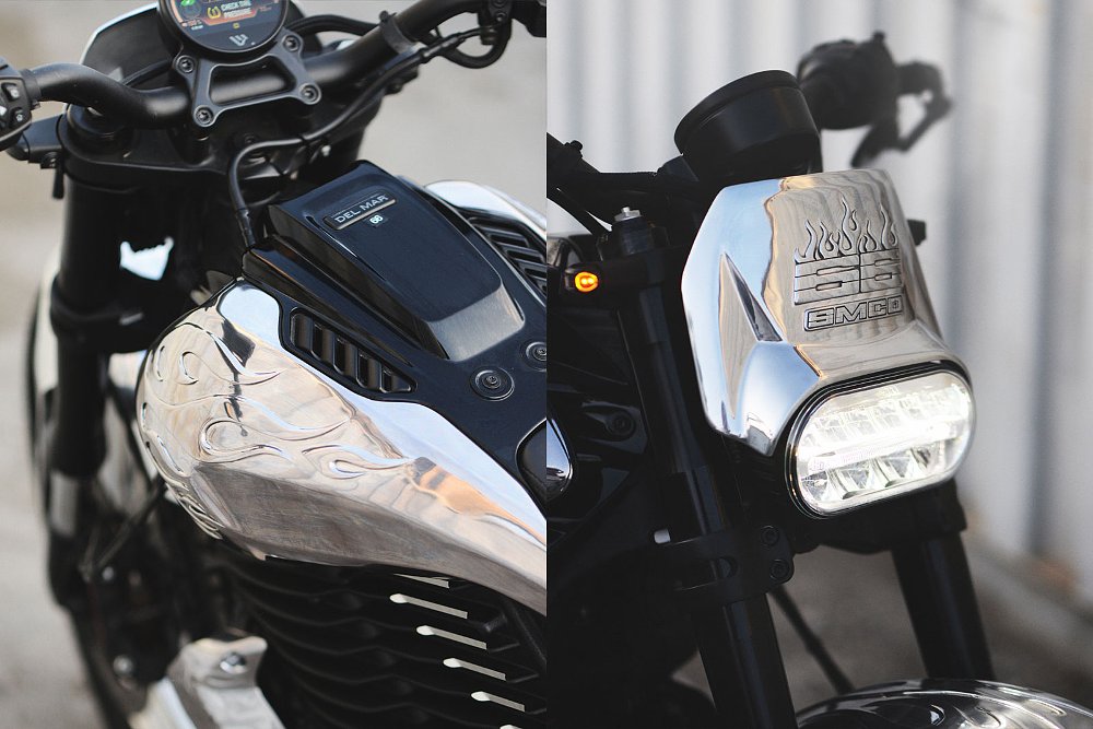 close view showing embossed figures on shiny metal body parts on the motorcycle