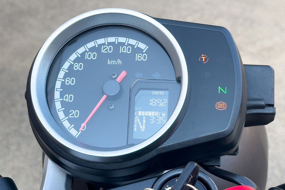 A close-up of the GB350's dash, which includes an analog speedometer, LCD insert, and instrument cluster.