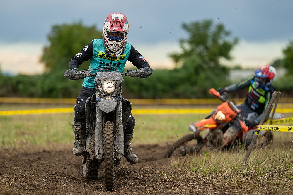 Two dirt bike riders trudge through the mud of the Italian Bike Week's test trail.
