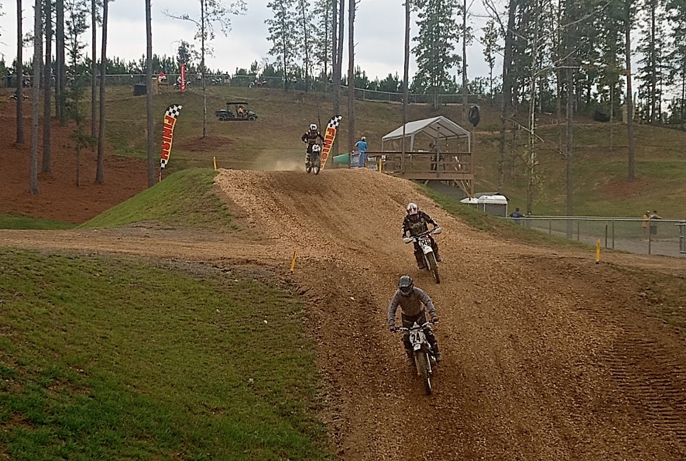 motocross bikes coming across the finish line jump
