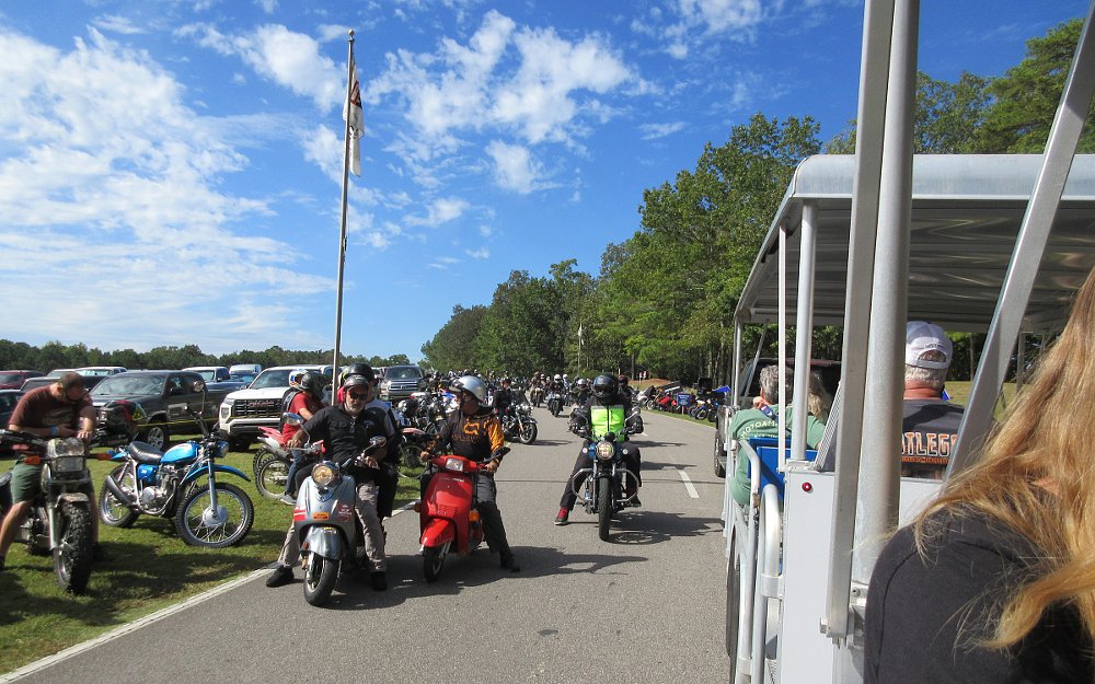 view from inside the tram of motorcycles going by on the perimeter road at Barber Motorsports Park